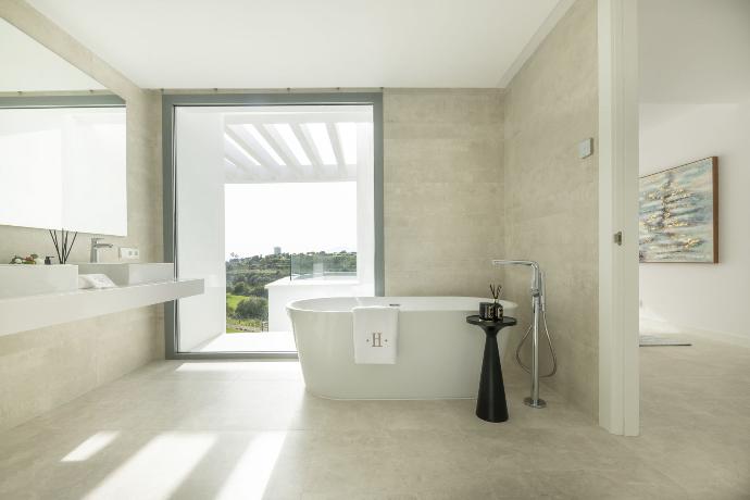 Beautiful picture of a luxury bathroom with personalized towels on the bath tub